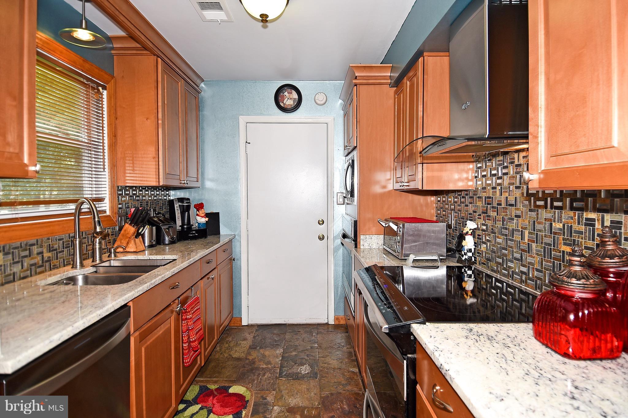 10313 Abbott Road Manassas, VA 20110 - Photo 12 of 30 a kitchen with stainless steel appliances granite countertop a sink stove and refrigerator