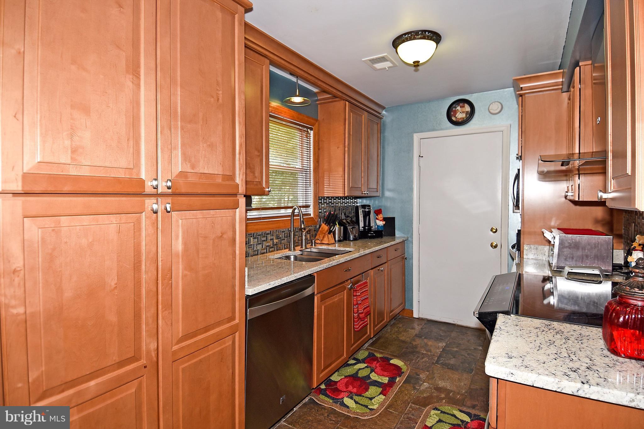 10313 Abbott Road Manassas, VA 20110 - Photo 13 of 30 a kitchen with stainless steel appliances granite countertop a refrigerator and a stove