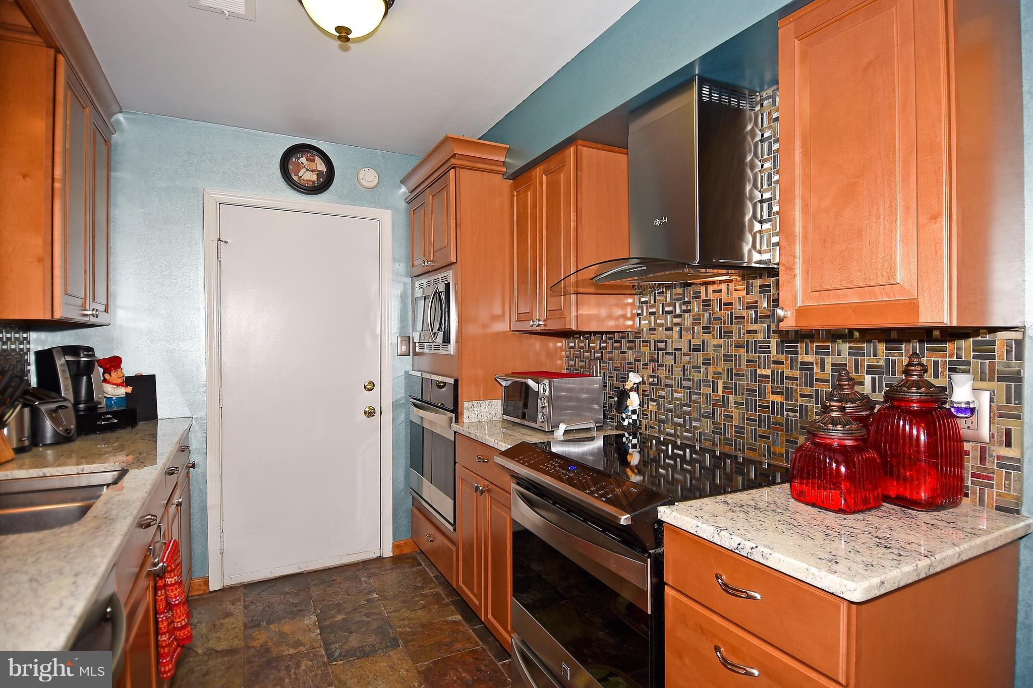 10313 Abbott Road Manassas, VA 20110 - Photo 14 of 30 a kitchen with stainless steel appliances granite countertop a stove a sink and a refrigerator