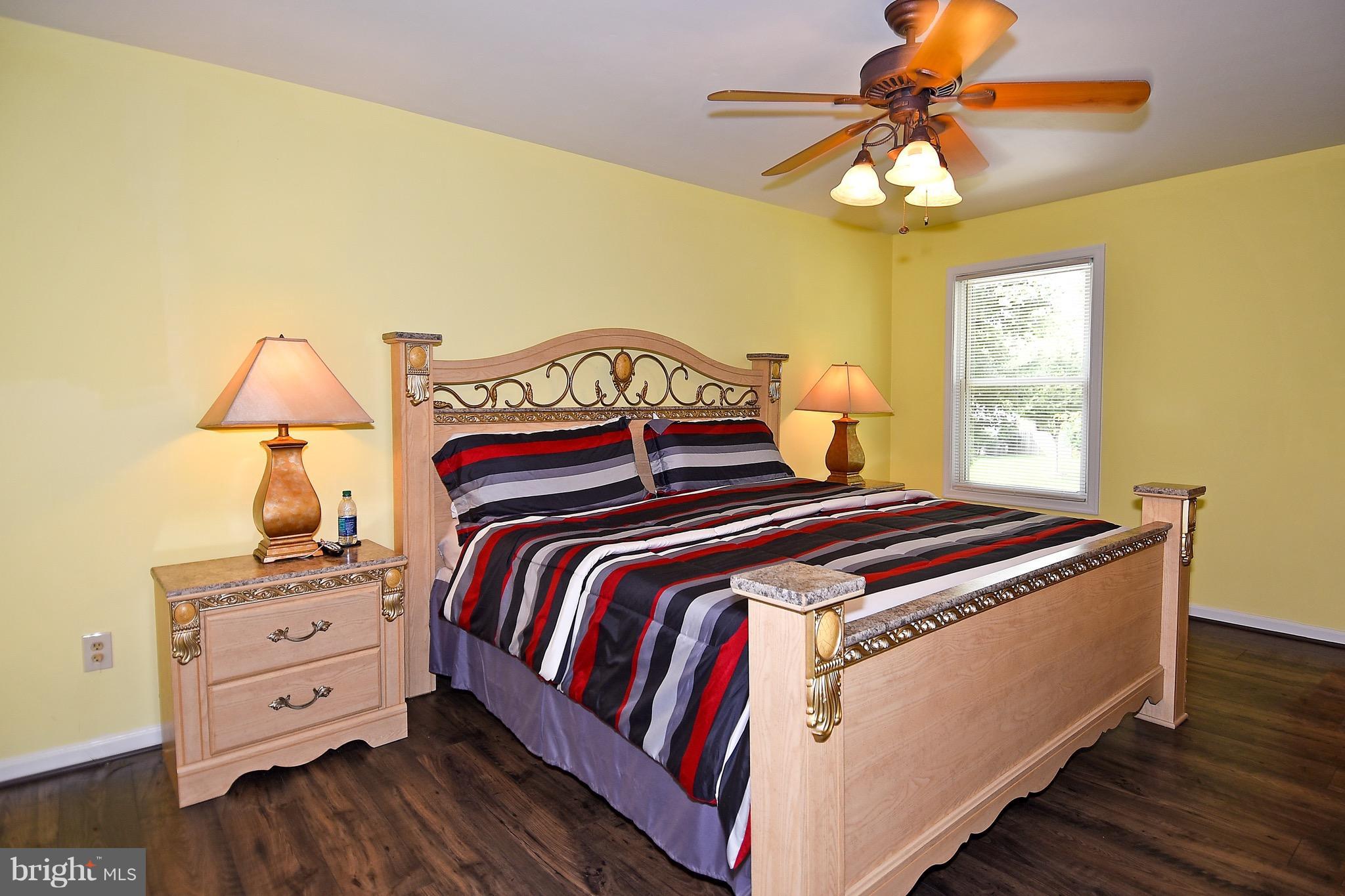 10313 Abbott Road Manassas, VA 20110 - Photo 17 of 30 a bedroom with a bed and a chandelier