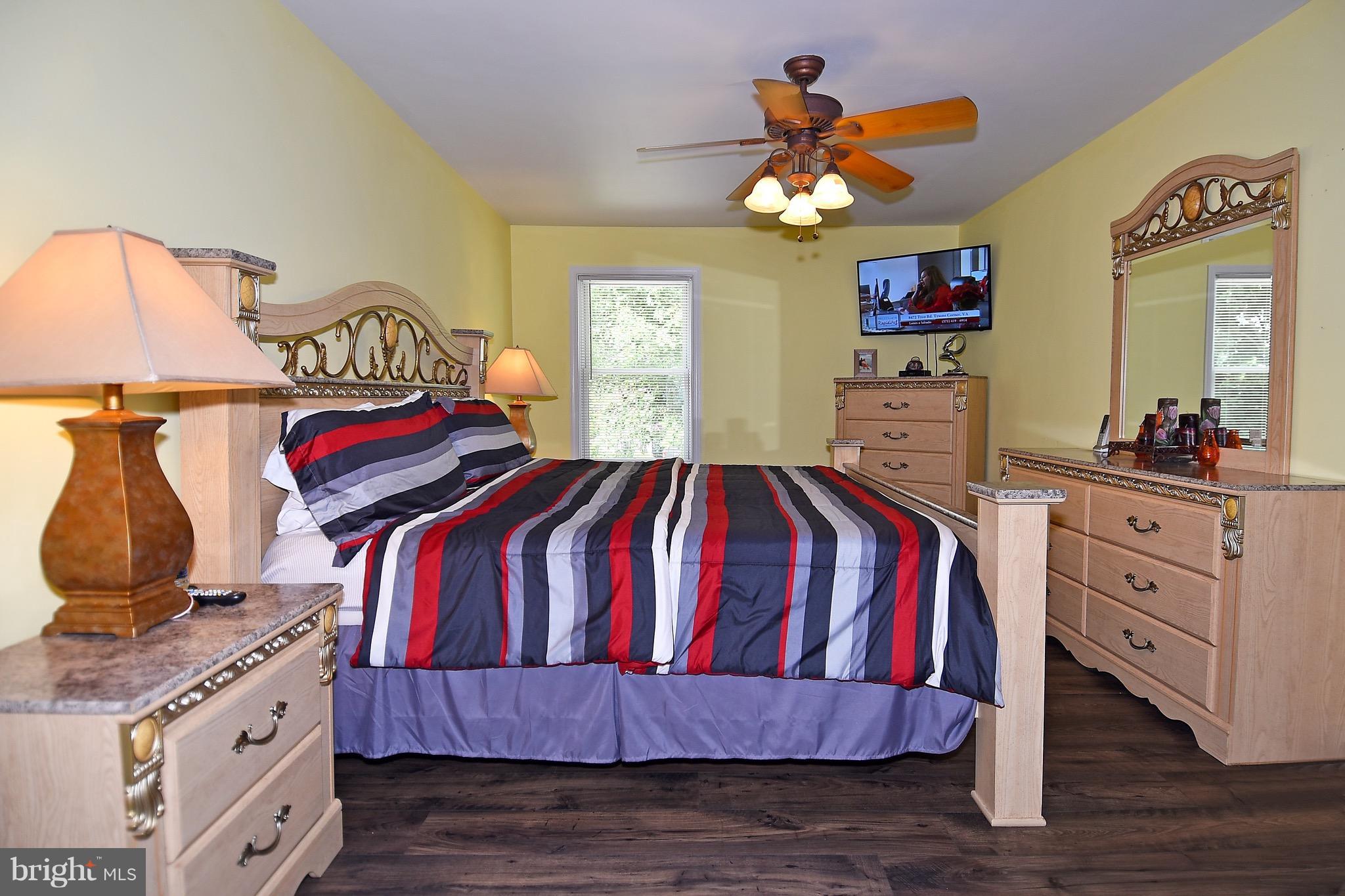 10313 Abbott Road Manassas, VA 20110 - Photo 18 of 30 a bedroom with a bed and wooden floor