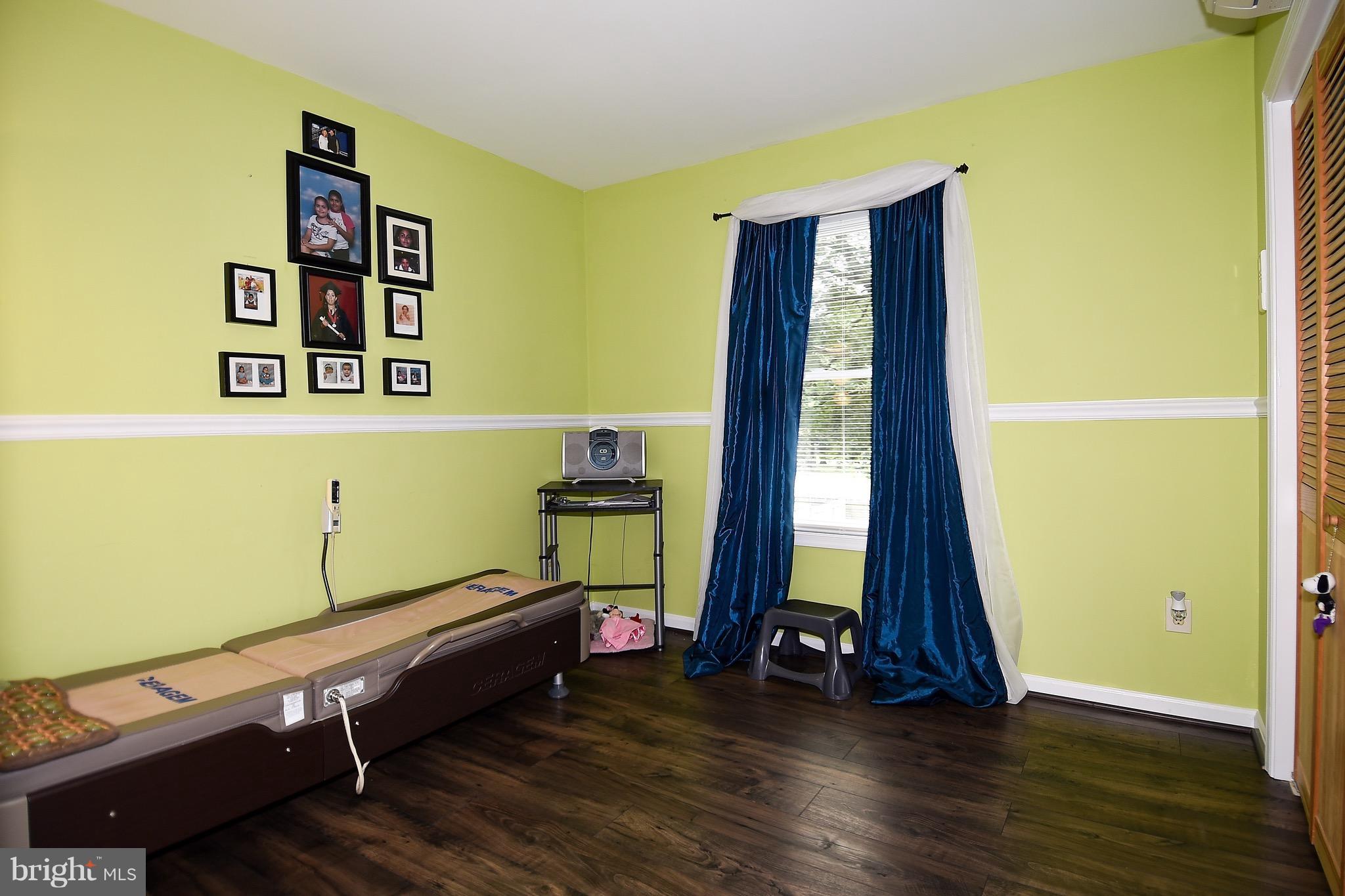 10313 Abbott Road Manassas, VA 20110 - Photo 21 of 30 a room with gym equipment with wooden floor