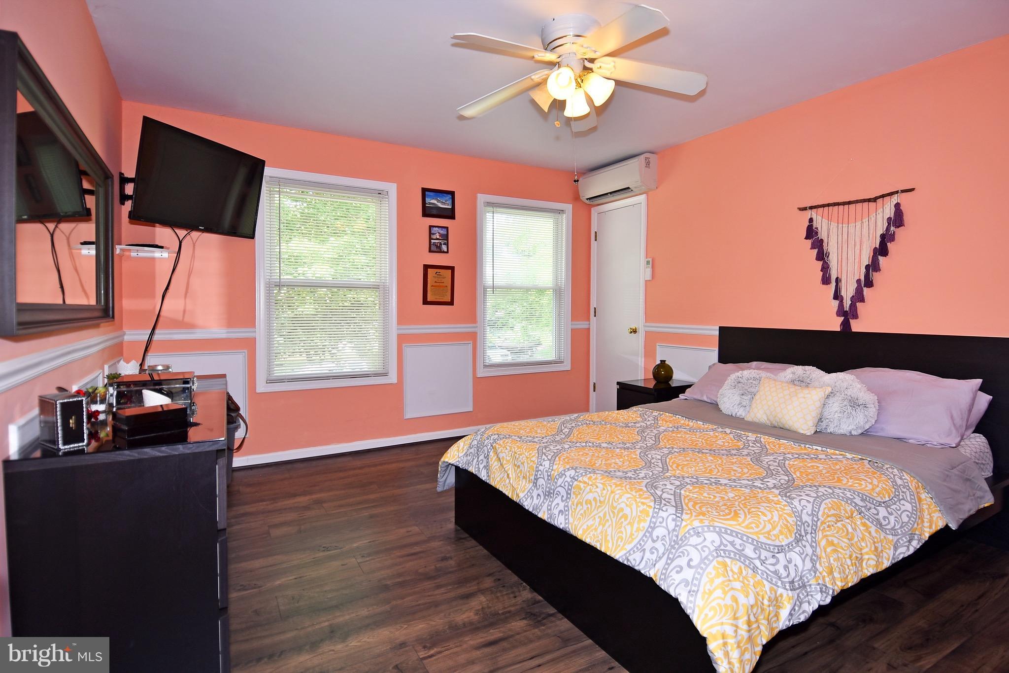 10313 Abbott Road Manassas, VA 20110 - Photo 23 of 30 a bedroom with a bed and a flat tv screen on dresser