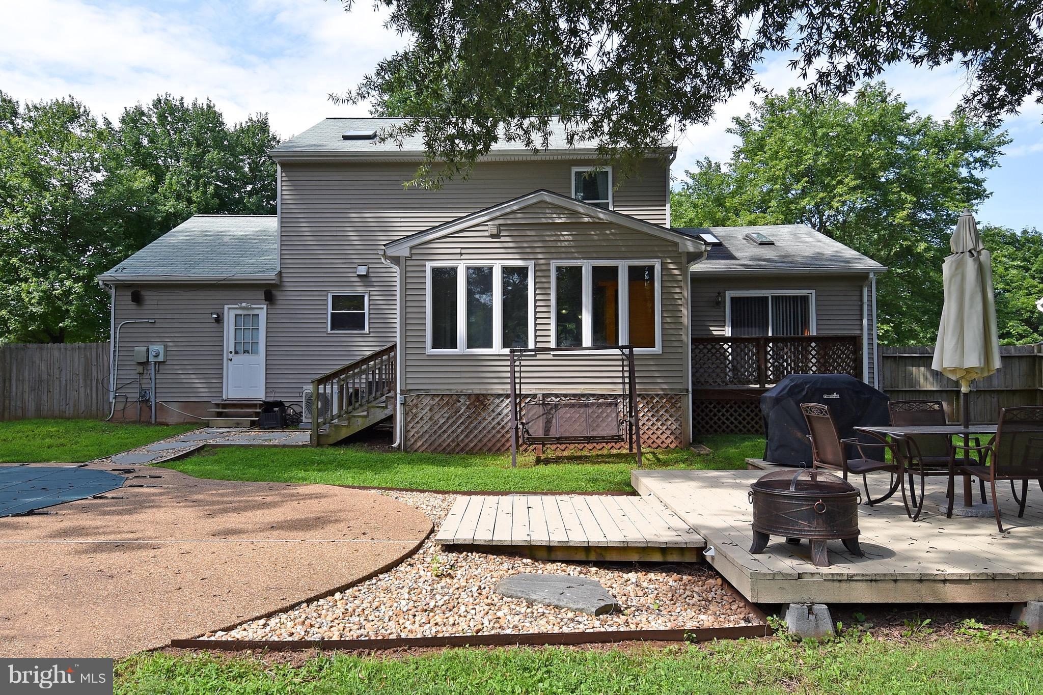 10313 Abbott Road Manassas, VA 20110 - Photo 28 of 30 a front view of a house with a yard table and chairs