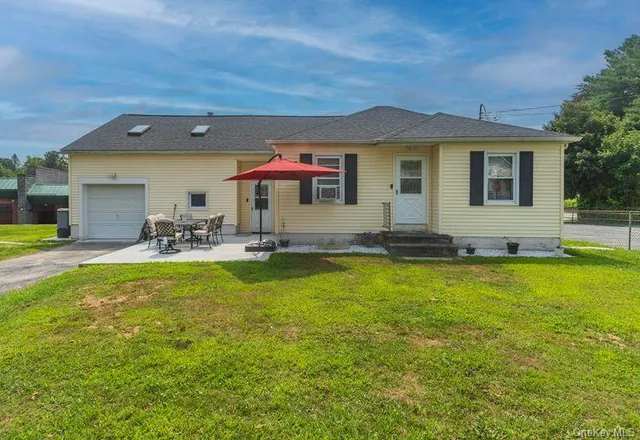 a front view of house with yard and seating area