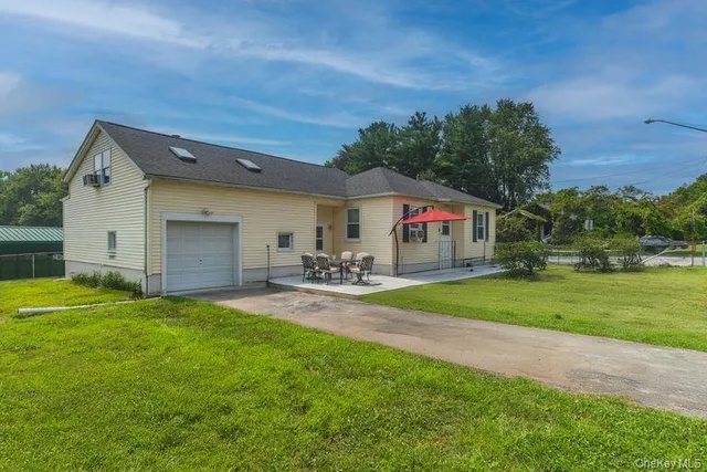 a view of a house with backyard and a garden