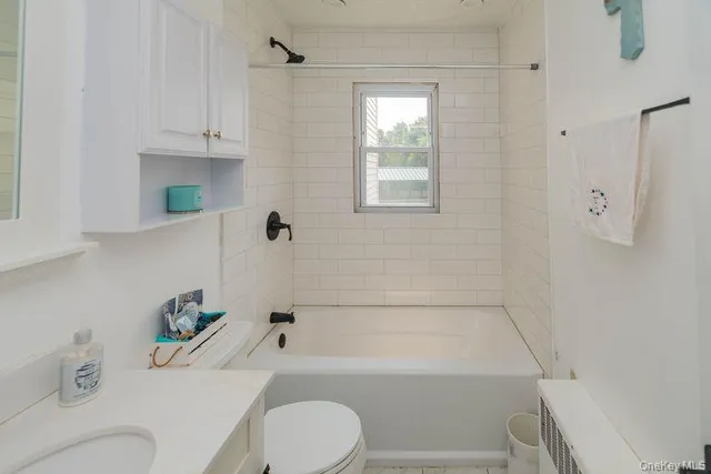 a bathroom with a bathtub a toilet and a shower