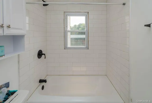 a large bed sitting in a bedroom next to a window