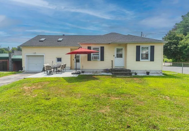 a front view of house with yard and seating area
