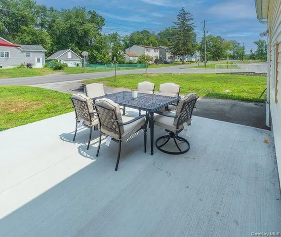 a view of a swimming pool and outdoor seating