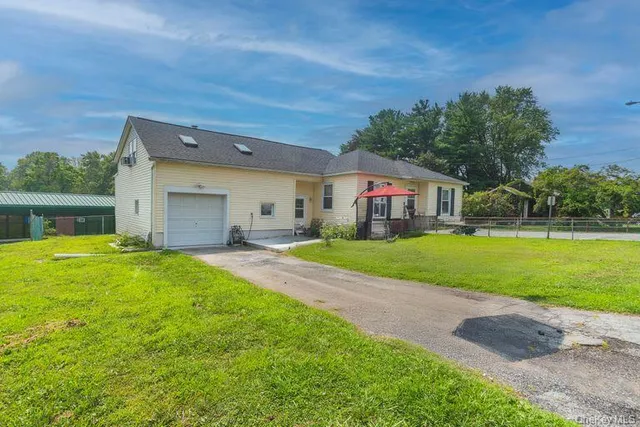 a yellow and red house with a yard