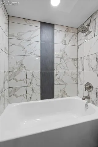 a bathroom with a bathtub and shower