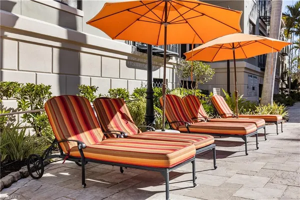 a city street lined with buildings and cars parked on the roadside