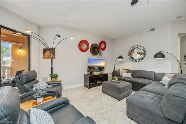 a kitchen with stainless steel appliances kitchen island granite countertop a refrigerator and cabinets