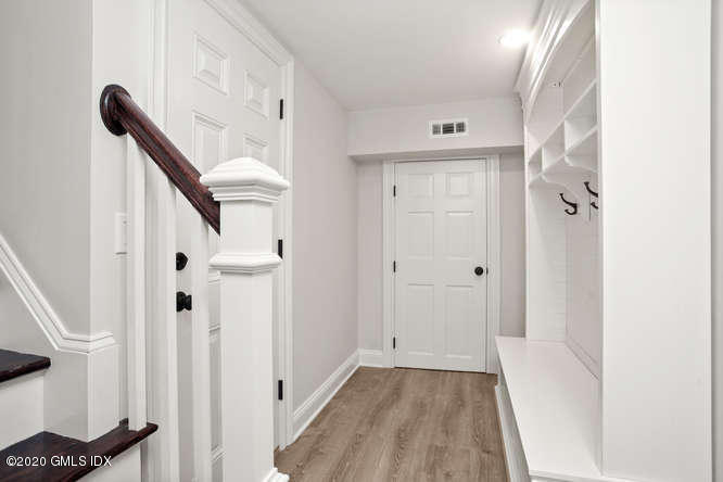 17 Hillside Drive Greenwich, CT 06830 - Photo 11 of 18 a view of a hallway with entryway wooden floor and front door