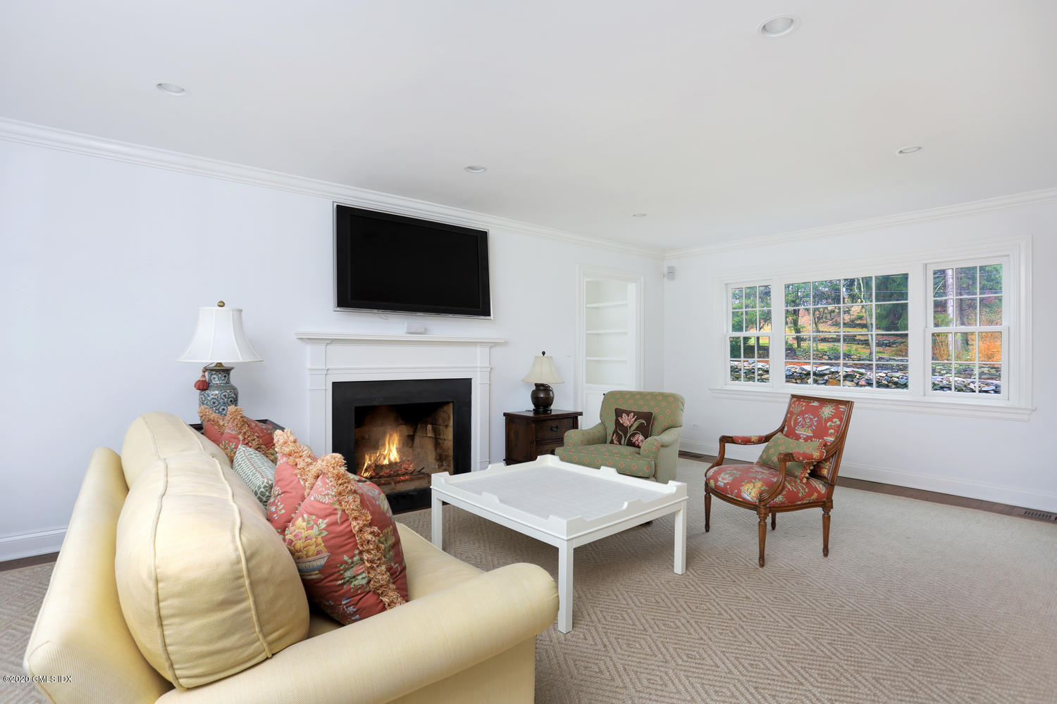 17 Hillside Drive Greenwich, CT 06830 - Photo 2 of 18 a living room with furniture a flat screen tv and a fireplace