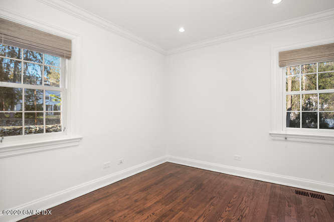 17 Hillside Drive Greenwich, CT 06830 - Photo 5 of 18 an empty room with wooden floor and windows
