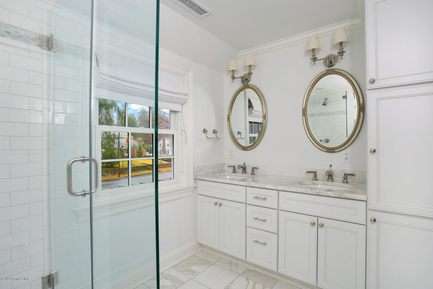 17 Hillside Drive Greenwich, CT 06830 - Photo 8 of 18 a bathroom with a sink a mirror and a light fixture