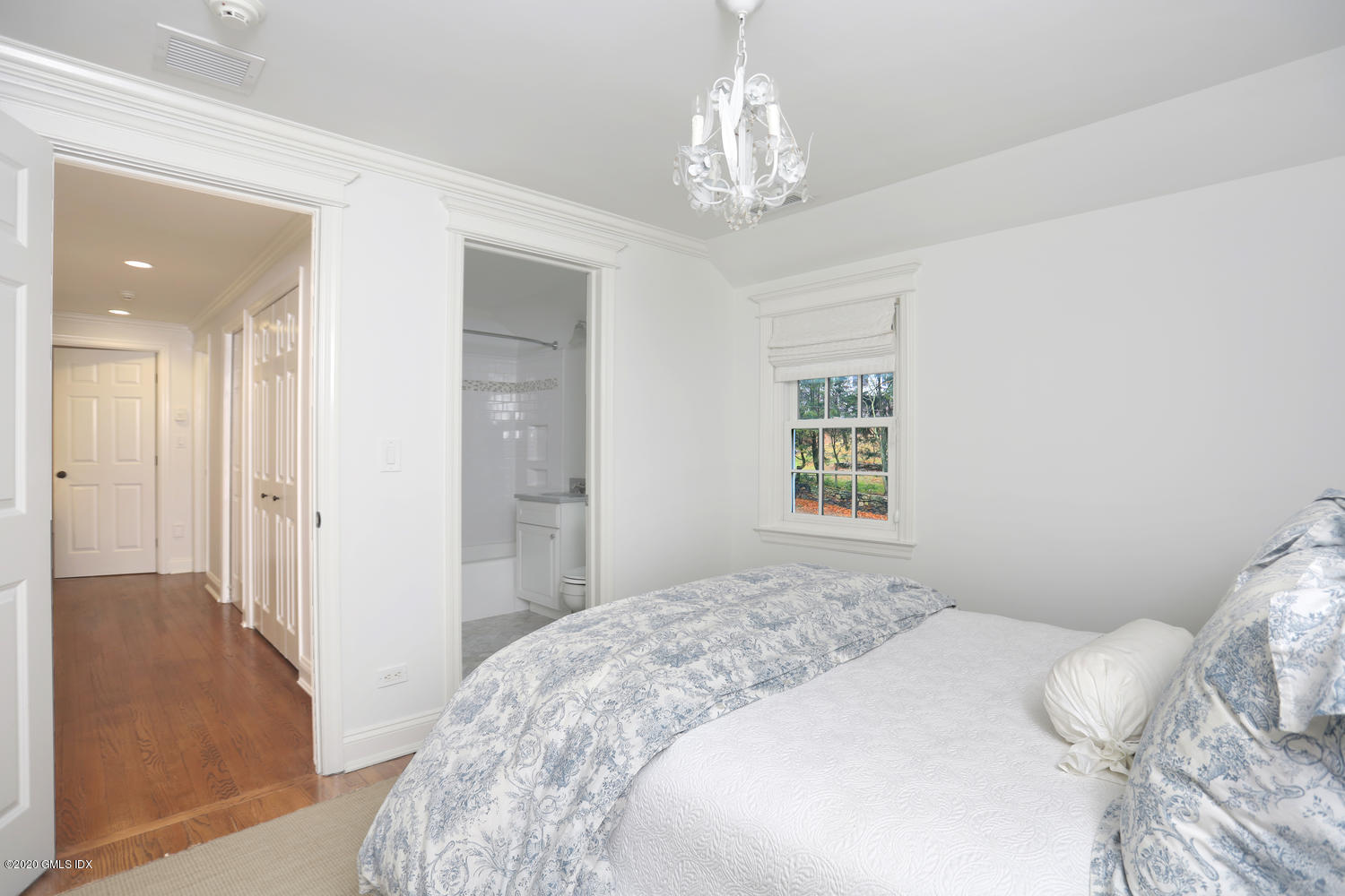 17 Hillside Drive Greenwich, CT 06830 - Photo 9 of 18 a bedroom with a large bed and a chandelier