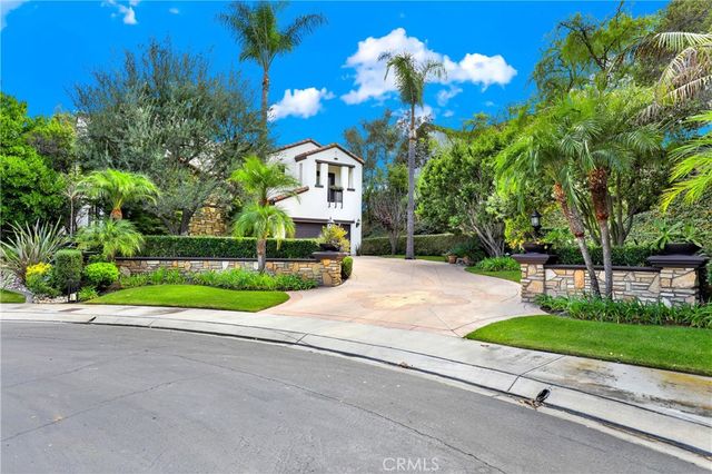 a view of a house with a yard and tree s