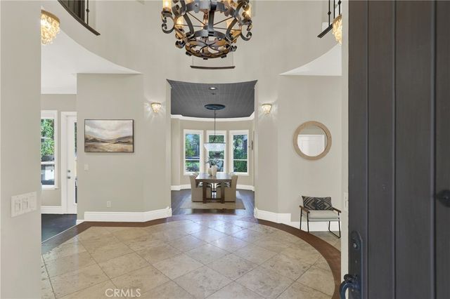 a living room with furniture and large windows