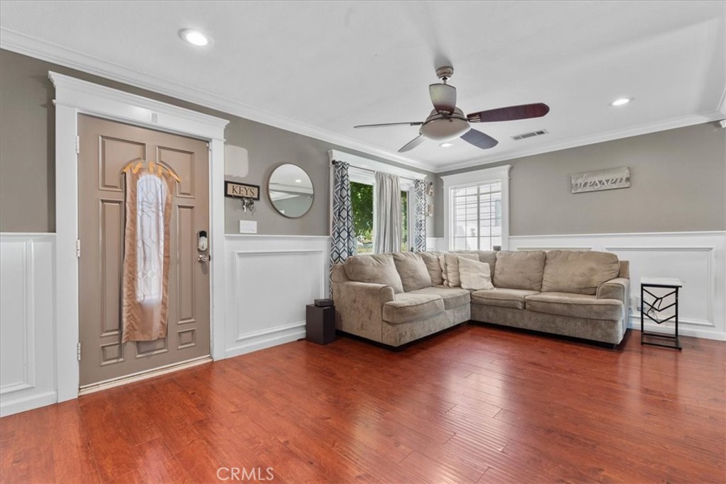 7167 Osbun Road San Bernardino, CA 92404 - Photo 20 of 35 a living room with furniture and a wooden floor