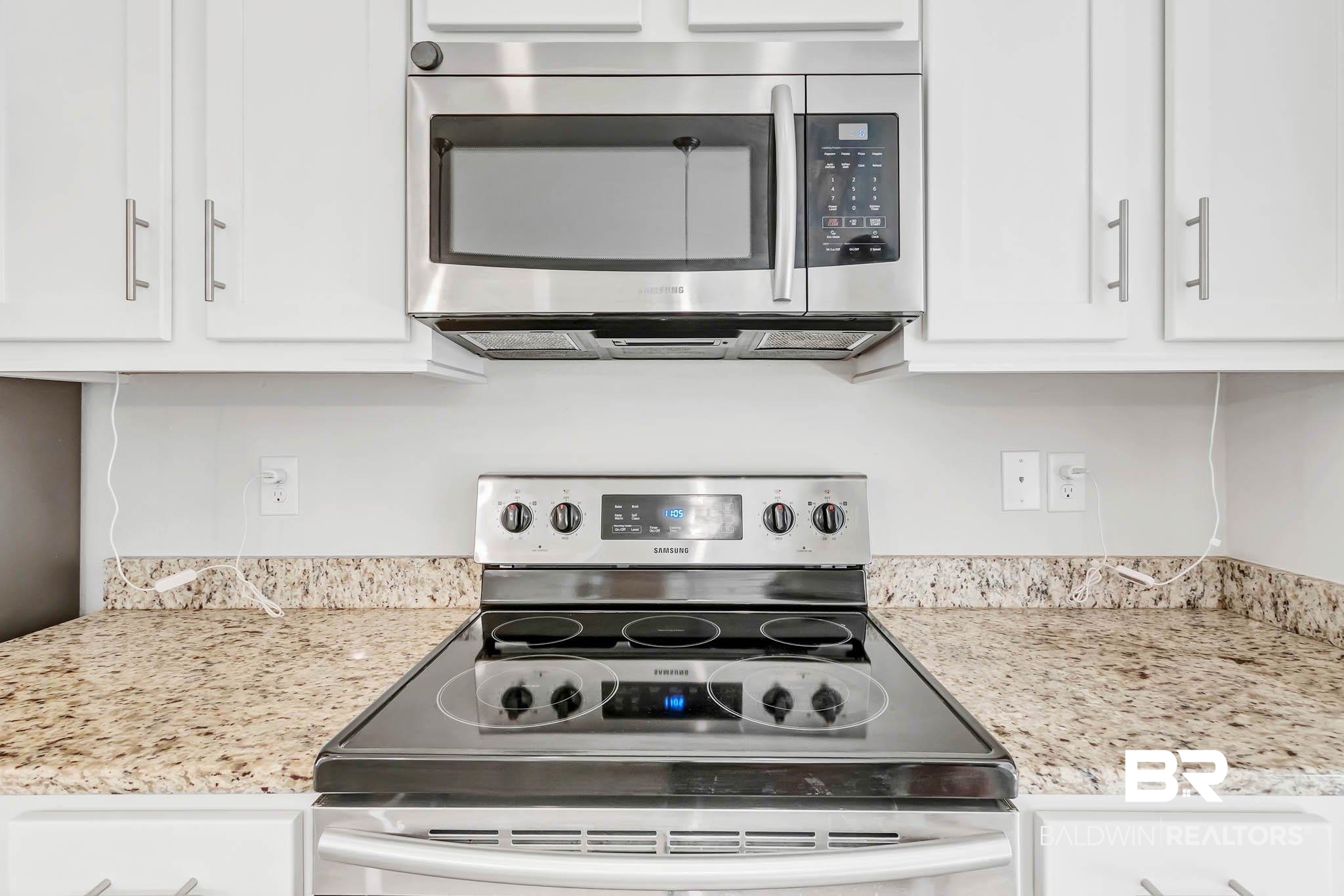 16461 Prado Loop Loxley, AL 36551 - Photo 13 of 78 Kitchen featuring stainless steel appliances, light stone countertops, and white cabinets
