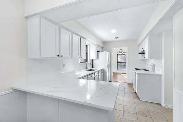 a kitchen with cabinets and a sink
