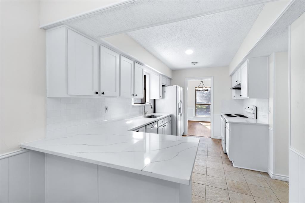 2543 Sundance Lane Dallas, TX 75287 - Photo 11 of 27 a kitchen with cabinets and a sink
