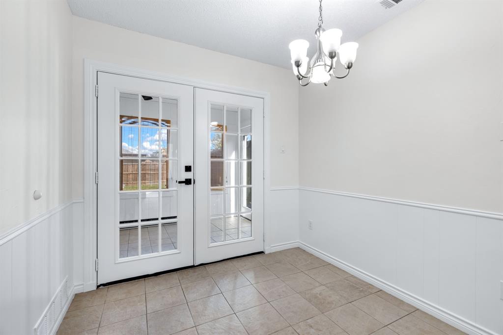 2543 Sundance Lane Dallas, TX 75287 - Photo 13 of 27 a view of a hallway with chandelier