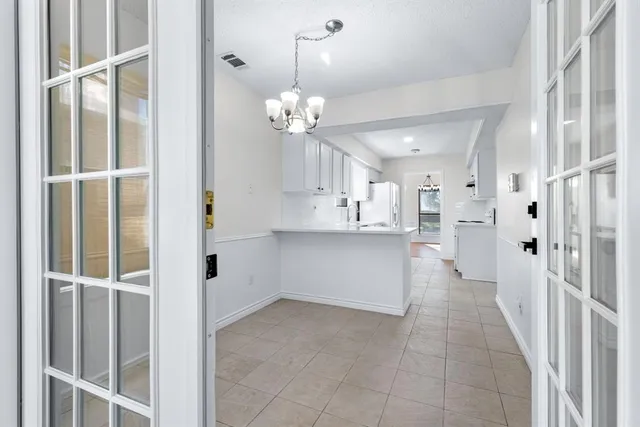 a view of a kitchen with a refrigerator and a cabinets