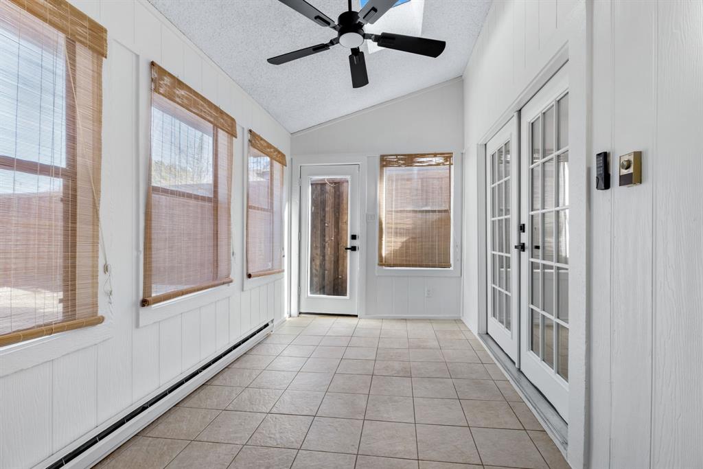 2543 Sundance Lane Dallas, TX 75287 - Photo 16 of 27 a view of a hallway to a livingroom with a chandelier fan and windows