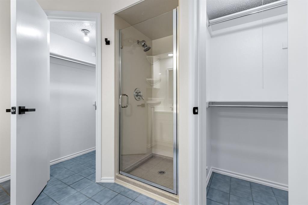 2543 Sundance Lane Dallas, TX 75287 - Photo 21 of 27 a bathroom with a glass shower door