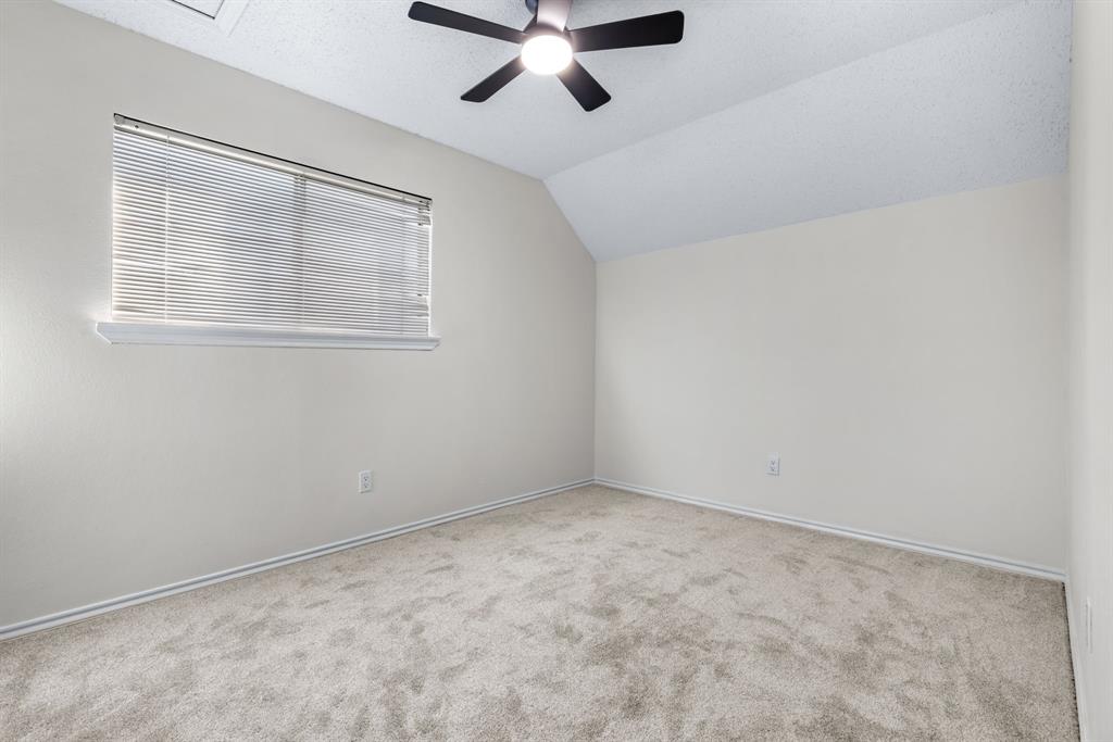 2543 Sundance Lane Dallas, TX 75287 - Photo 22 of 27 an empty room with ceiling fan and windows