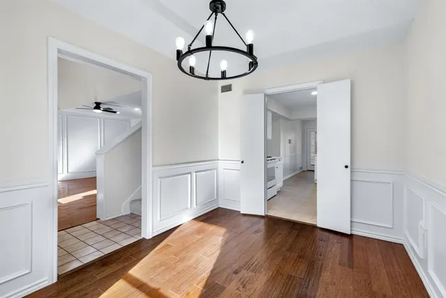 a view of a room with wooden floor and staircase