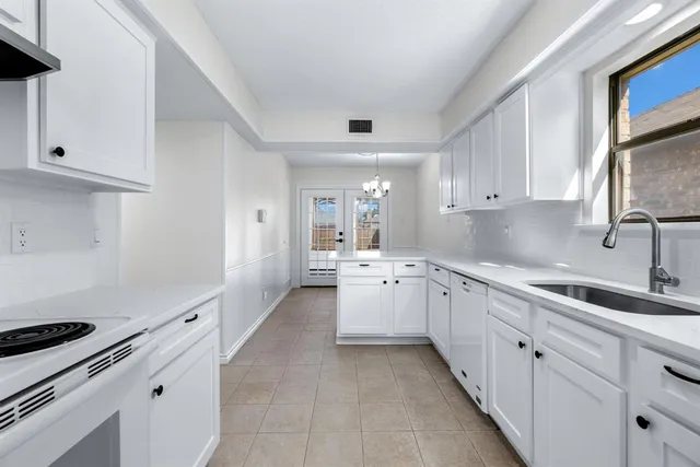 a kitchen with a sink stove and cabinets
