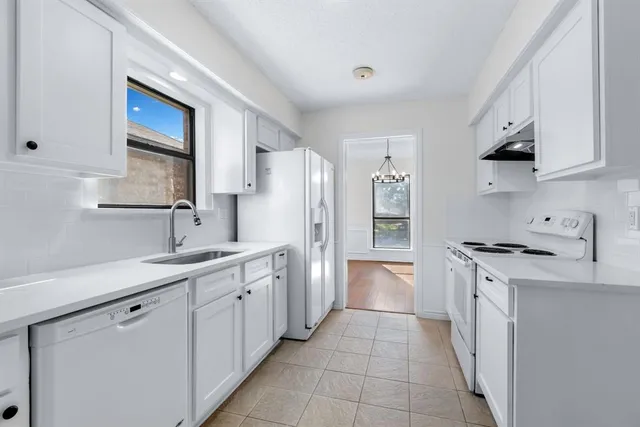 a kitchen with stainless steel appliances a sink stove and cabinets