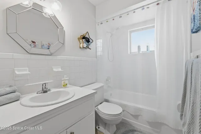 a living room with furniture a large window and a table