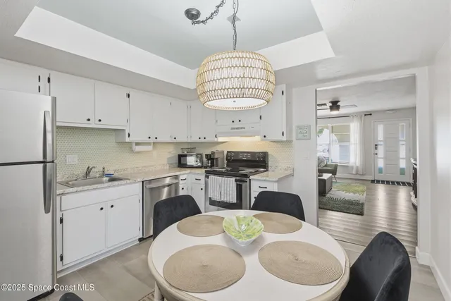 a view of a house with a tree in front of it