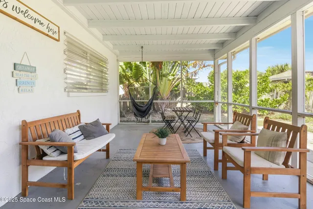 an empty room with wooden floor and a ceiling fan
