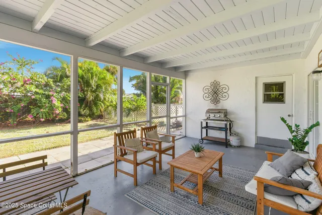 a kitchen with a dining table chairs and white cabinets