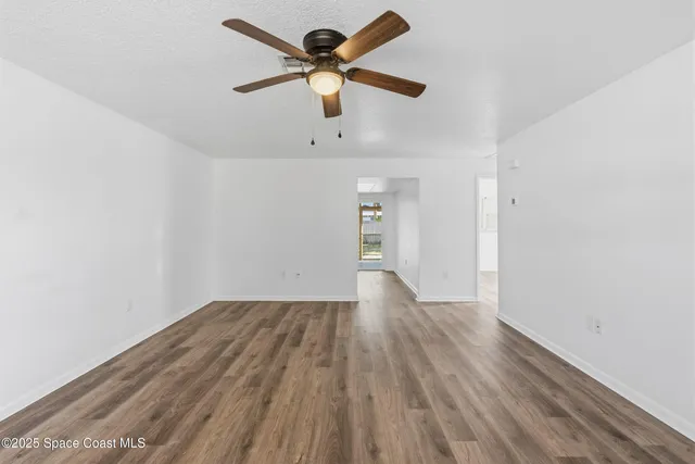an outdoor sitting area with couch and chairs