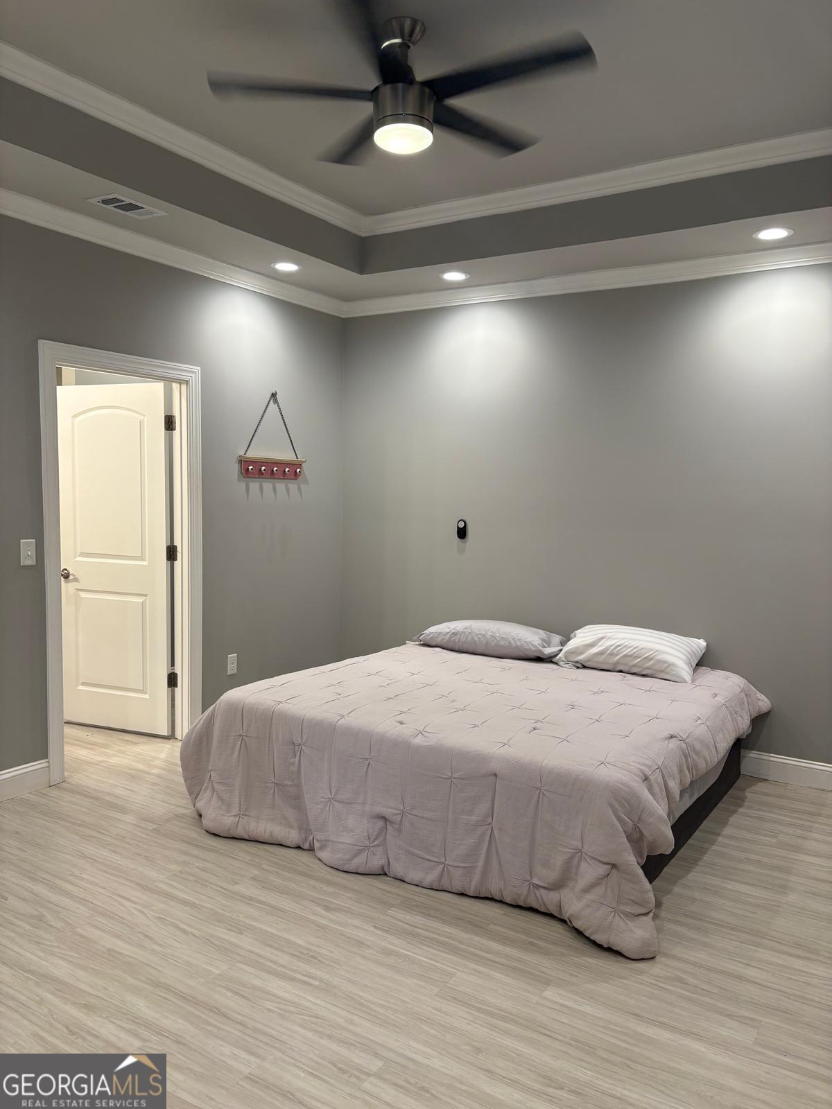 388 Forest Avenue Baxley, GA 31513 - Photo 13 of 28 a bedroom with a bed and a ceiling fan