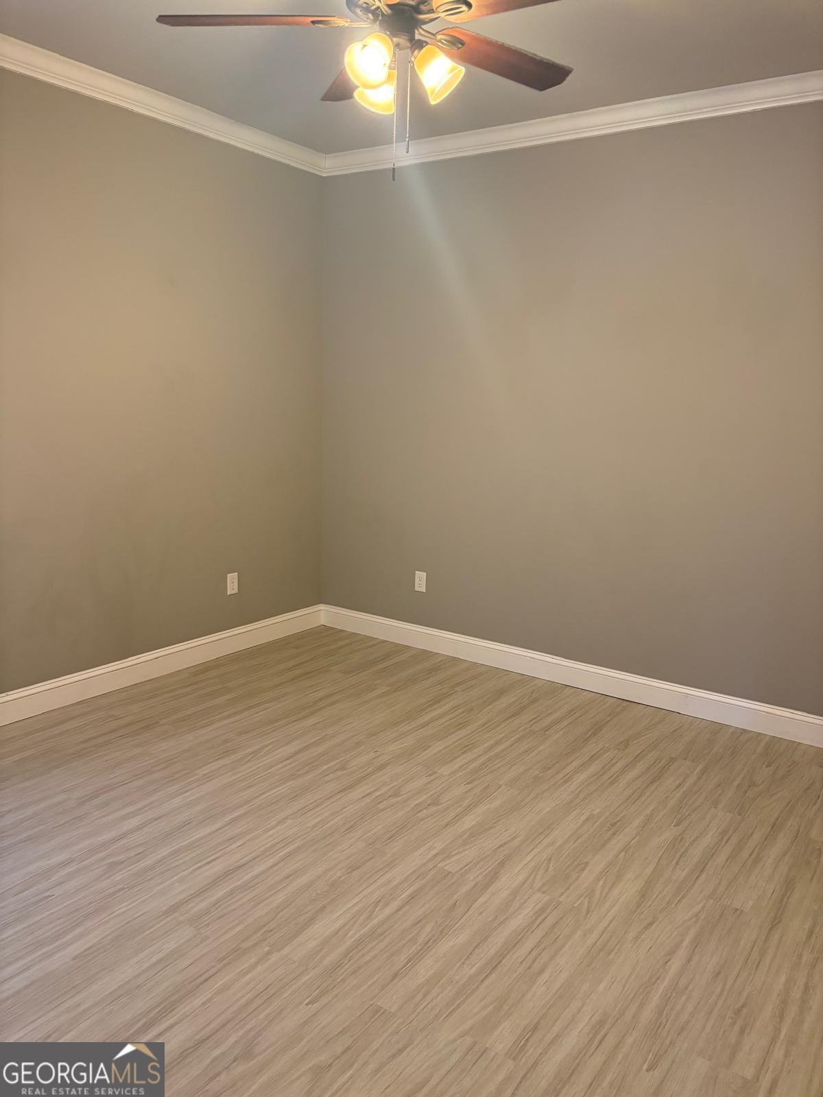388 Forest Avenue Baxley, GA 31513 - Photo 15 of 28 a view of an empty room with wooden floor and a window