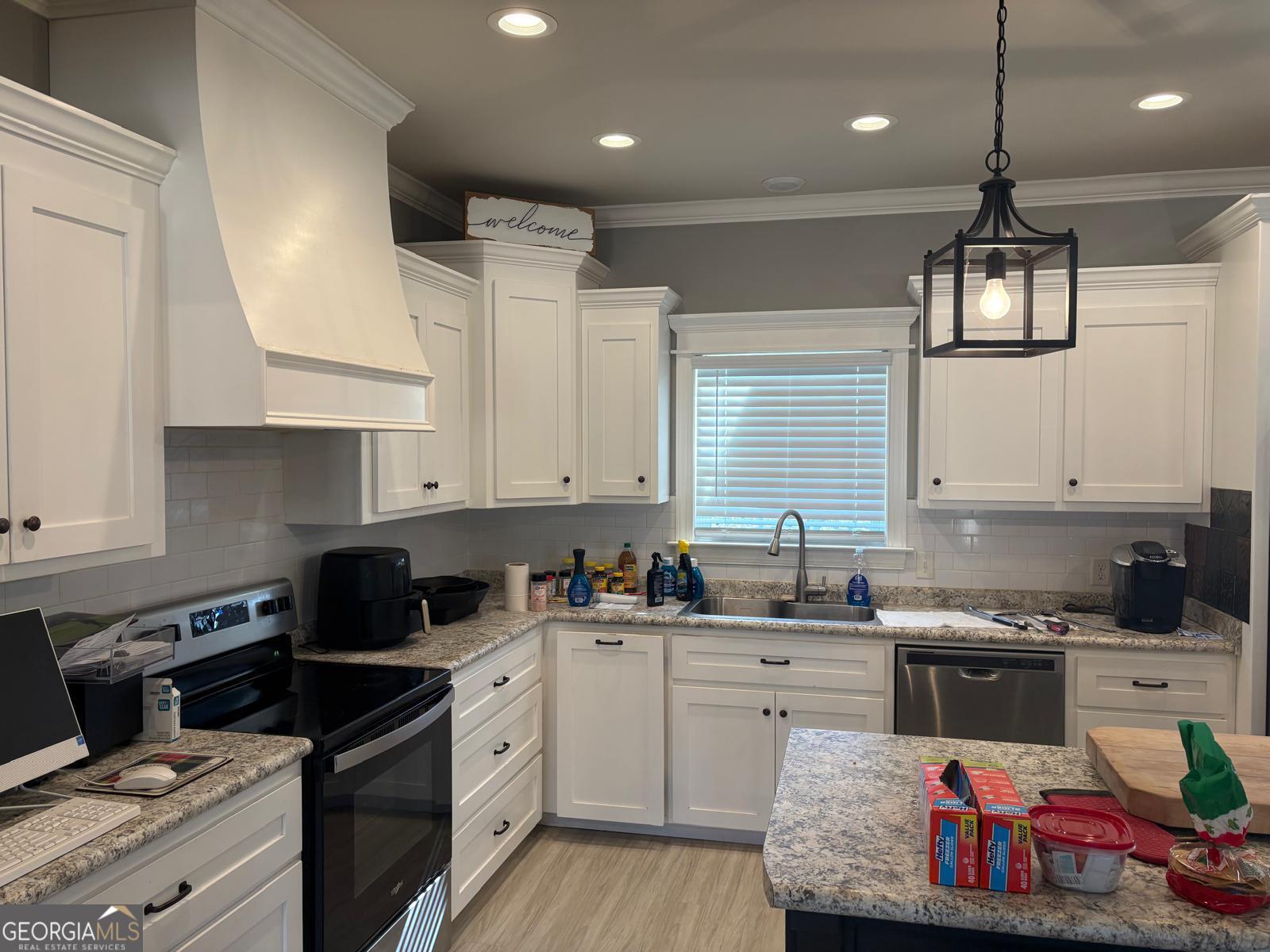 388 Forest Avenue Baxley, GA 31513 - Photo 8 of 28 a kitchen with a sink stove and cabinets
