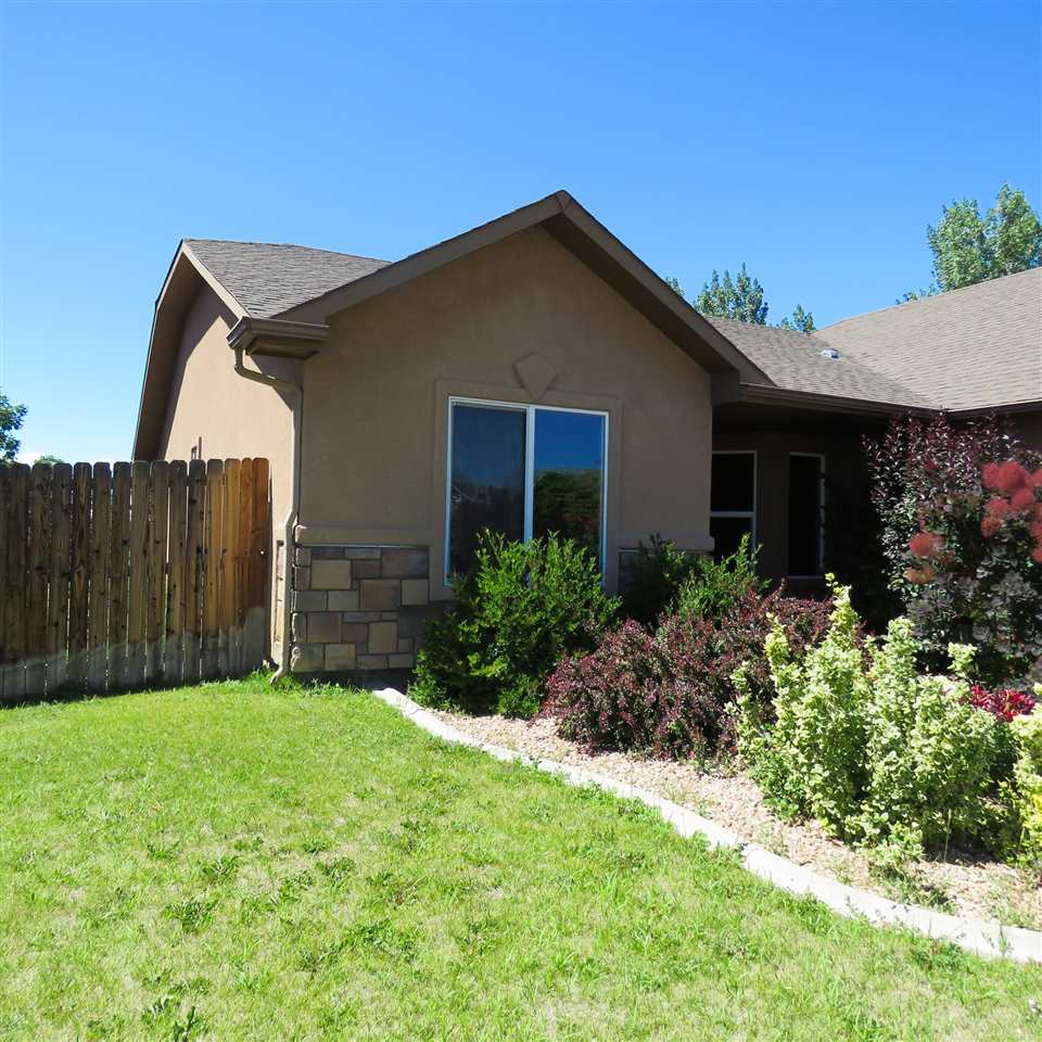 983 Kaley Street Fruita, CO 81521 - Photo 18 of 28 a front view of house with yard and green space