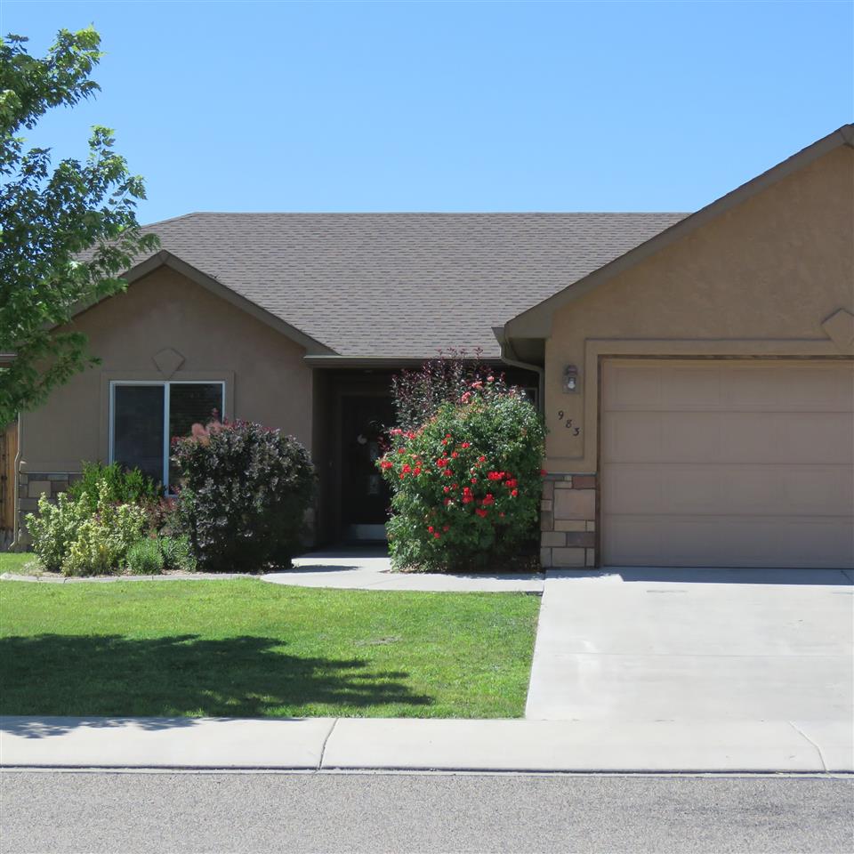 983 Kaley Street Fruita, CO 81521 - Photo 19 of 28 a front view of a house with a yard