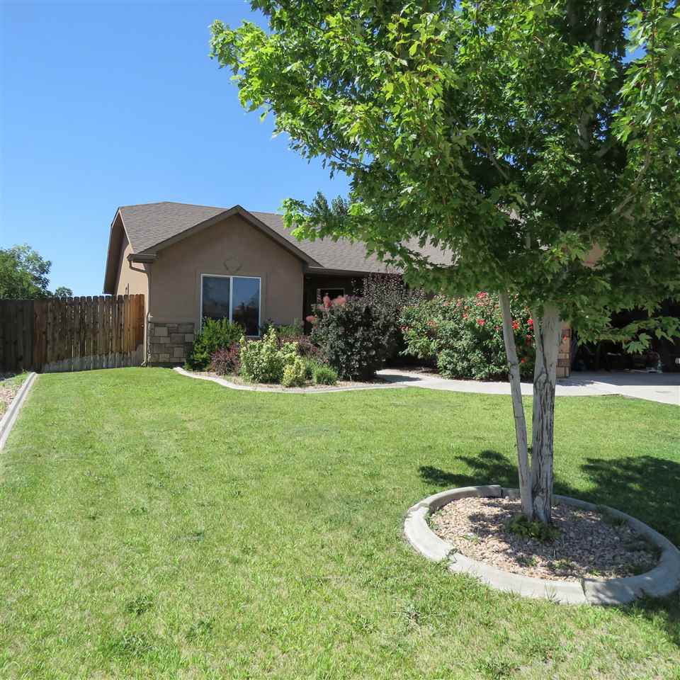 983 Kaley Street Fruita, CO 81521 - Photo 21 of 28 a front view of a house with a yard