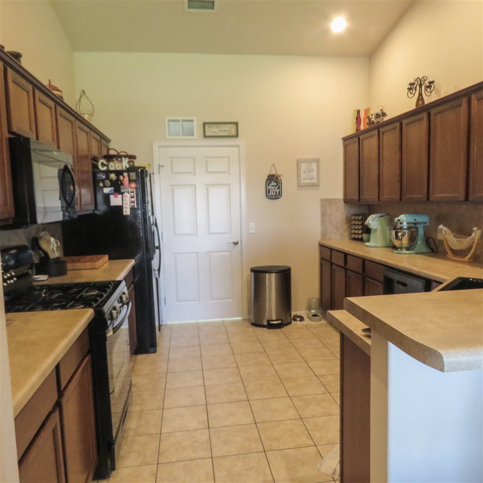 983 Kaley Street Fruita, CO 81521 - Photo 3 of 28 a kitchen with a refrigerator and a stove