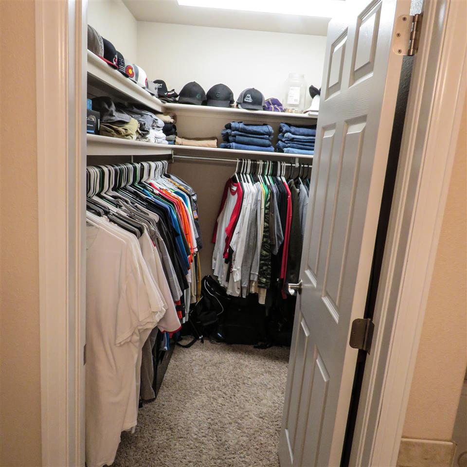 983 Kaley Street Fruita, CO 81521 - Photo 8 of 28 a view of walk in closet with clothes and shoes